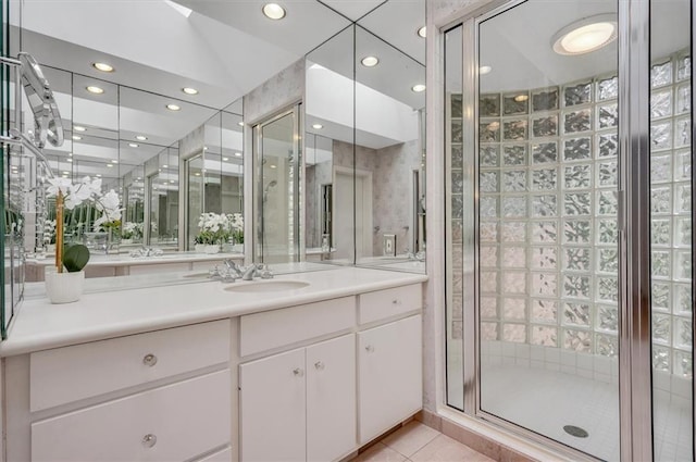 full bath featuring recessed lighting, a shower stall, vanity, and tile patterned floors