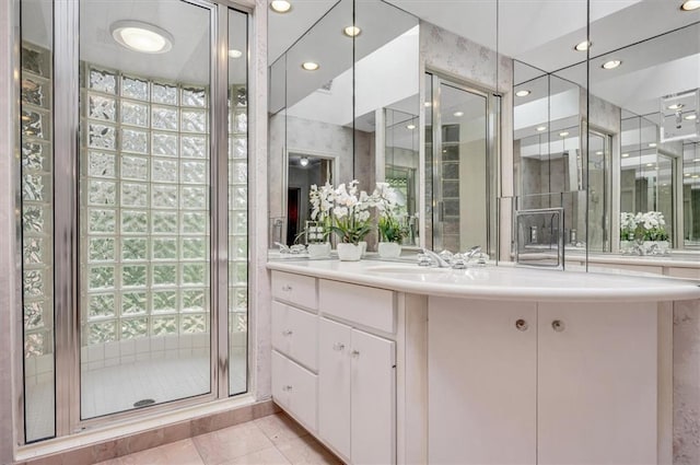 full bath with a stall shower, tile patterned flooring, and vanity