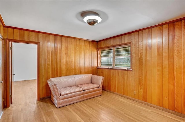 sitting room featuring wood walls and wood finished floors