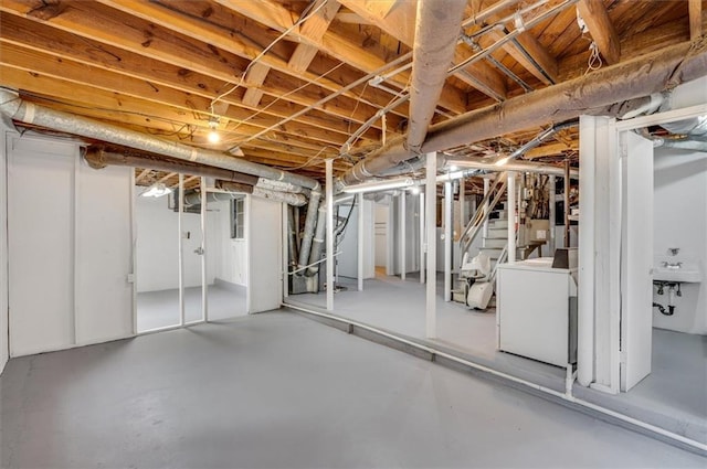 unfinished basement with washer / dryer and a sink