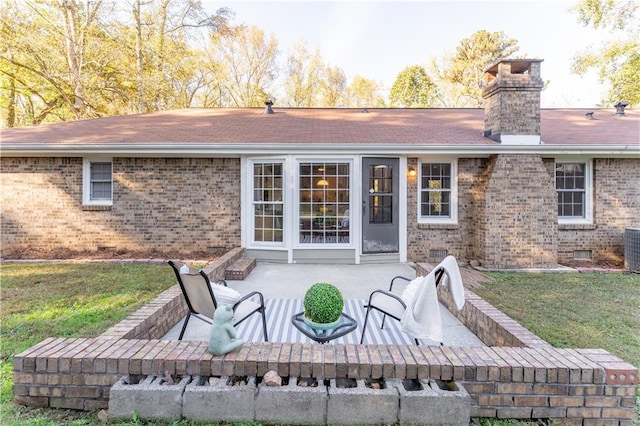 back of house with a lawn and a patio area