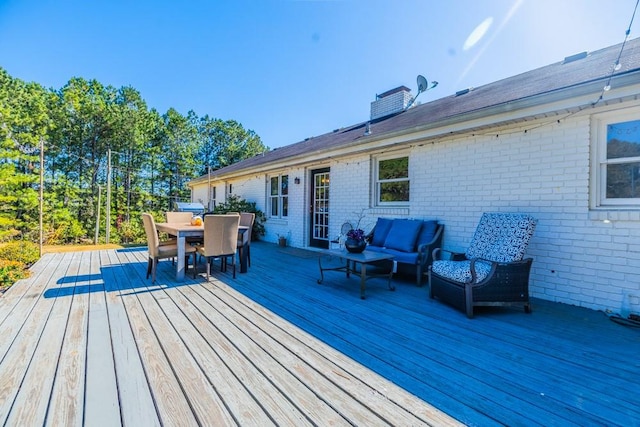 wooden terrace with an outdoor hangout area