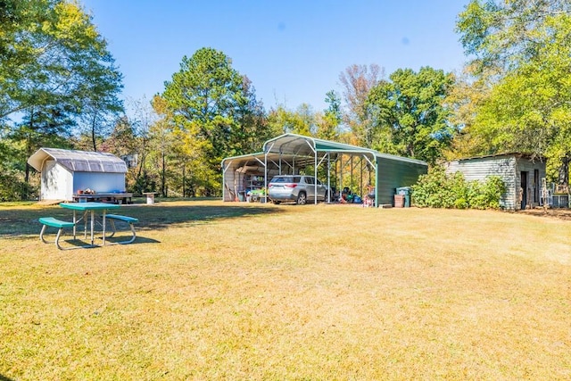 view of yard featuring a carport and a storage unit