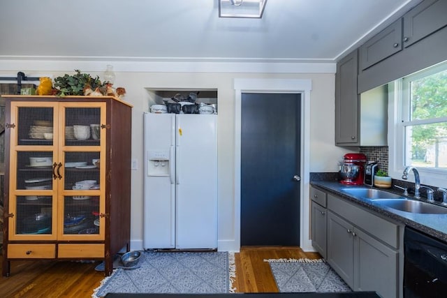 kitchen with dark hardwood / wood-style flooring, sink, white refrigerator with ice dispenser, and dishwasher