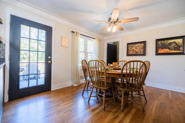 dining space featuring crown molding, ceiling fan, and dark hardwood / wood-style floors