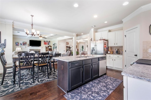 466 Sweet Apple Ln, Buford, GA 30518 - kitchen featuring appliances with stainless steel finishes, ornamental molding, a sink, a chandelier, and white cabinetry