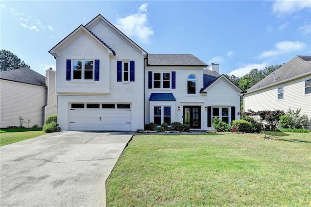 9440 Knollcrest Blvd, Alpharetta, GA 30022 - view of front of house featuring a garage, driveway, a chimney, and a front yard