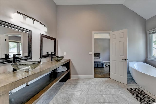 9440 Knollcrest Blvd, Alpharetta, GA 30022 - full bath with ensuite bath, a soaking tub, marble look tile flooring, plenty of natural light, and high vaulted ceiling