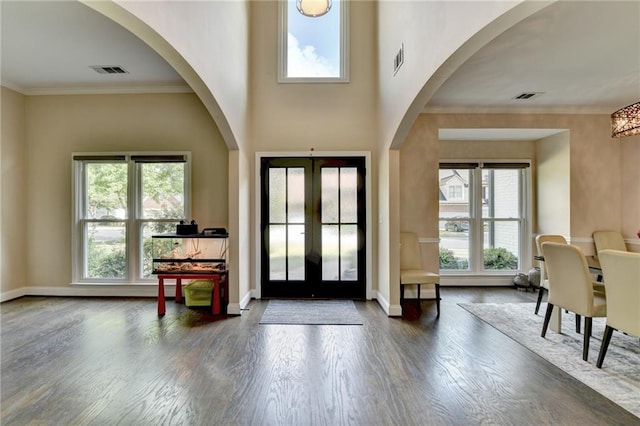 9440 Knollcrest Blvd, Alpharetta, GA 30022 - foyer entrance with wood finished floors, french doors, ornamental molding, baseboards, and arched walkways