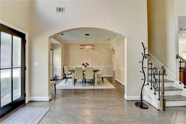 9440 Knollcrest Blvd, Alpharetta, GA 30022 - entrance foyer with arched walkways, healthy amount of natural light, wood finished floors, and ornamental molding