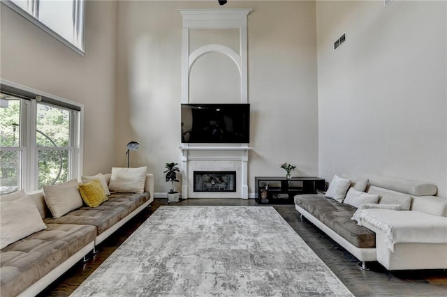 9440 Knollcrest Blvd, Alpharetta, GA 30022 - living room with a high ceiling, a fireplace with flush hearth, and dark wood-style floors