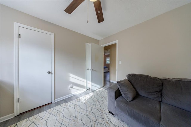 living room featuring light hardwood / wood-style flooring and ceiling fan