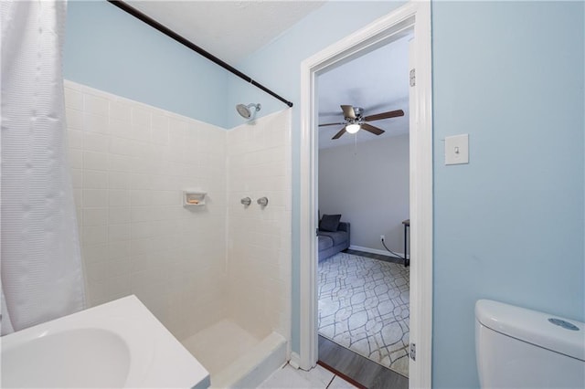 bathroom with ceiling fan, toilet, and walk in shower