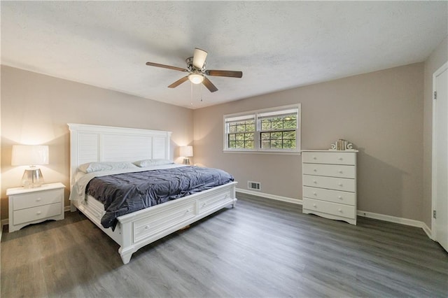 bedroom with dark hardwood / wood-style floors and ceiling fan