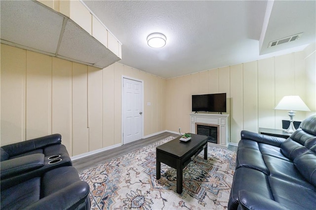 living room featuring hardwood / wood-style flooring and a textured ceiling