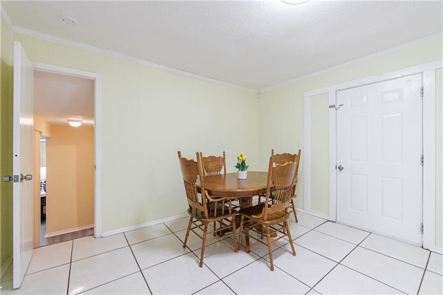 dining room with light tile patterned floors and ornamental molding