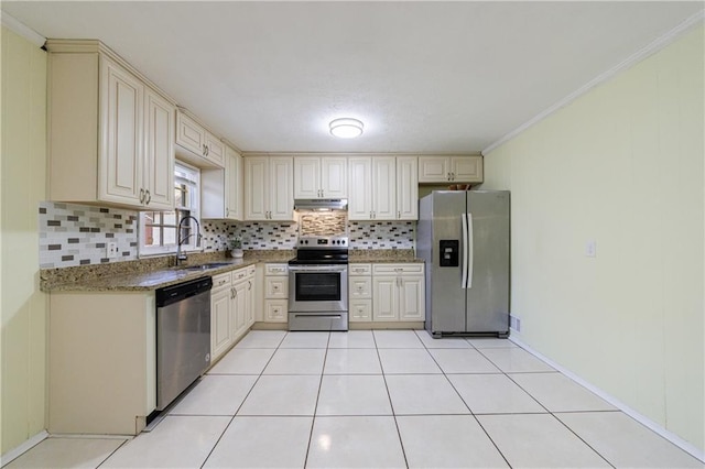 kitchen with tasteful backsplash, sink, stainless steel appliances, and stone countertops