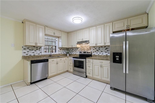 kitchen with sink, light tile patterned floors, backsplash, stainless steel appliances, and stone countertops