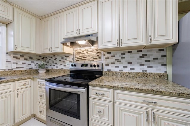 kitchen featuring tasteful backsplash, light stone countertops, and stainless steel electric range