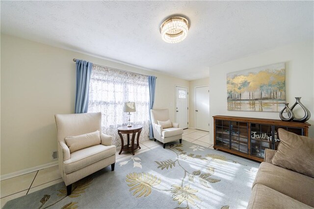 tiled living room featuring a textured ceiling