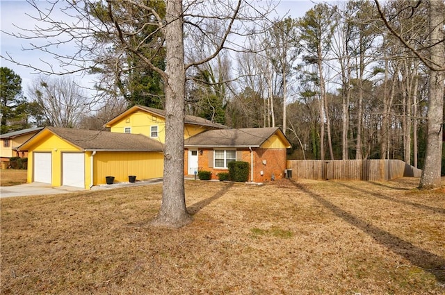 view of front of property featuring a garage and a front lawn