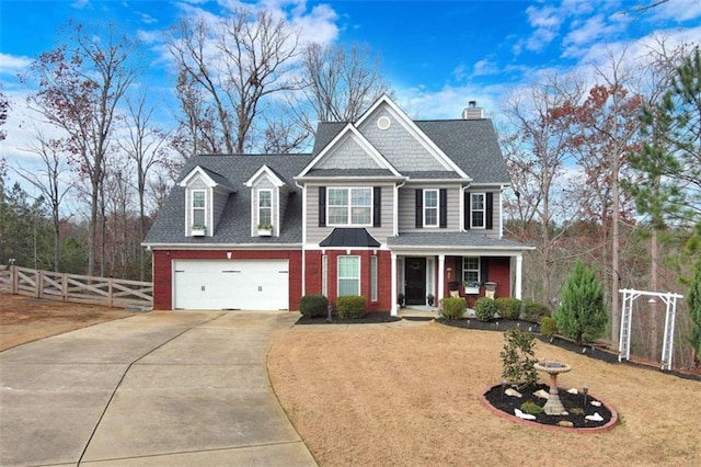 view of front of house featuring brick siding, a chimney, a porch, fence, and driveway