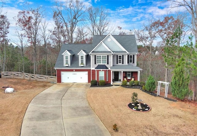 view of front of home with driveway, a shingled roof, an attached garage, covered porch, and fence