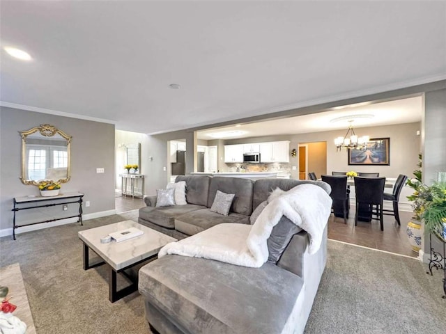 living area with a notable chandelier, crown molding, and light carpet