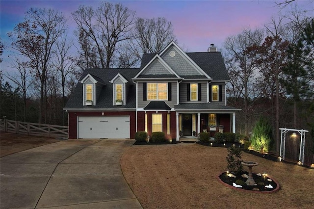 view of front of home featuring brick siding, concrete driveway, covered porch, fence, and a garage