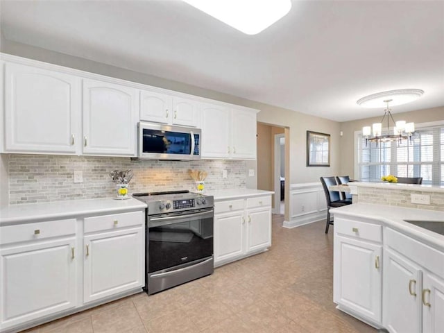 kitchen featuring light countertops, appliances with stainless steel finishes, and white cabinets