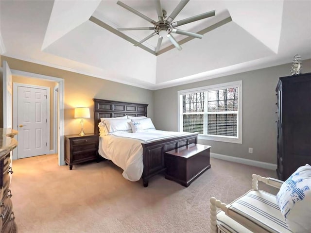 bedroom featuring baseboards, a tray ceiling, and light colored carpet