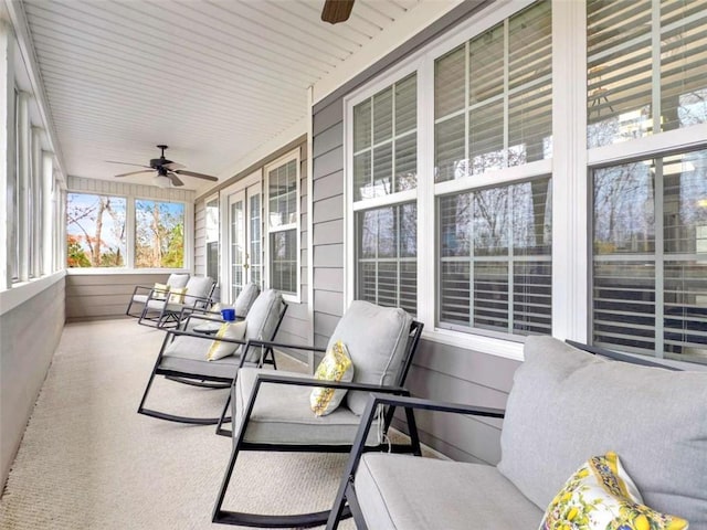 sunroom / solarium with a ceiling fan