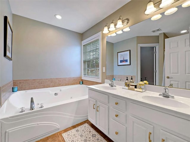 full bathroom featuring a bath, visible vents, a sink, and tile patterned floors