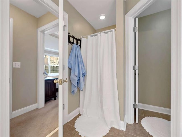 bathroom with tile patterned floors, baseboards, and a shower with shower curtain