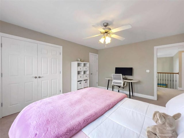 carpeted bedroom featuring a closet, a ceiling fan, and baseboards