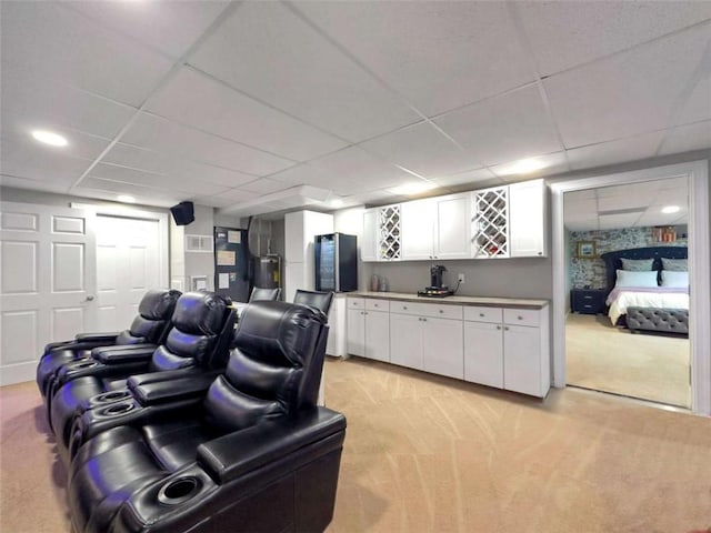 interior space featuring light carpet and a paneled ceiling