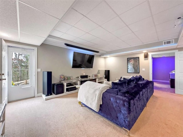 living area featuring baseboards, carpet flooring, visible vents, and a drop ceiling