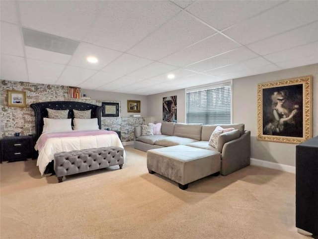 carpeted bedroom featuring a paneled ceiling and baseboards