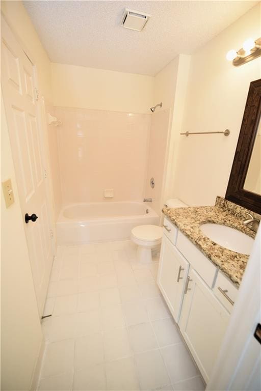1075 Peachtree Walk NE Unit A519, Atlanta, GA 30309 - bathroom with a textured ceiling, toilet, bathtub / shower combination, visible vents, and vanity