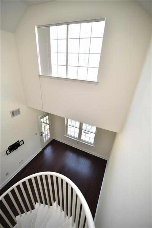 1075 Peachtree Walk NE Unit A519, Atlanta, GA 30309 - stairway with visible vents, wood finished floors, and a towering ceiling