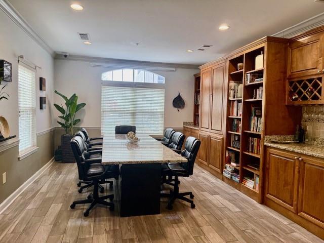 1075 Peachtree Walk NE Unit A519, Atlanta, GA 30309 - home office featuring recessed lighting, a wealth of natural light, light wood-style floors, and crown molding