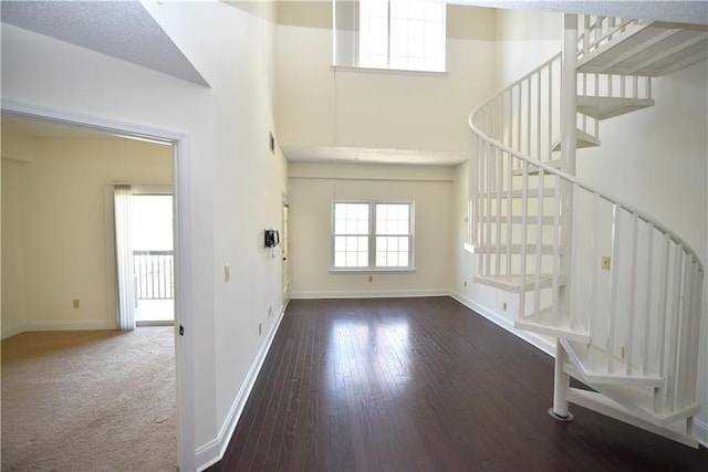 1075 Peachtree Walk NE Unit A519, Atlanta, GA 30309 - foyer entrance featuring wood-type flooring, baseboards, a towering ceiling, and stairs