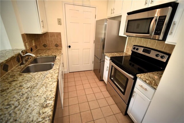 1075 Peachtree Walk NE Unit A519, Atlanta, GA 30309 - kitchen featuring backsplash, white cabinetry, stainless steel appliances, and a sink