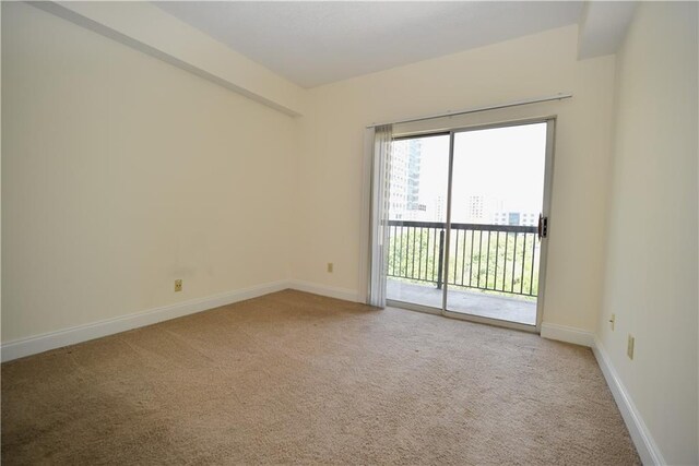 1075 Peachtree Walk NE Unit A519, Atlanta, GA 30309 - spare room featuring baseboards and light carpet