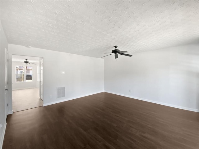 unfurnished room with visible vents, a ceiling fan, a textured ceiling, wood finished floors, and baseboards