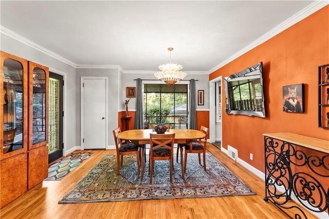 2511 Oak Ave, Tucker, GA 30084 - dining room with a chandelier, wood finished floors, ornamental molding, and baseboards