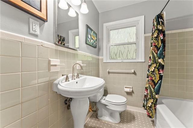2511 Oak Ave, Tucker, GA 30084 - full bathroom with tile walls, toilet, a wainscoted wall, shower / bath combo, and tile patterned flooring