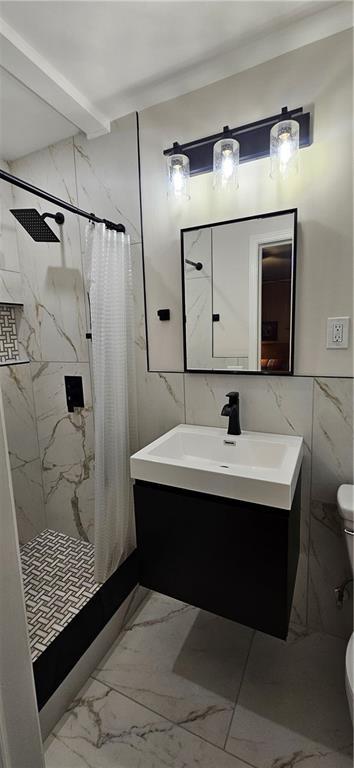 2511 Oak Ave, Tucker, GA 30084 - bathroom with marble finish floors, a stall shower, toilet, vanity, and tile walls