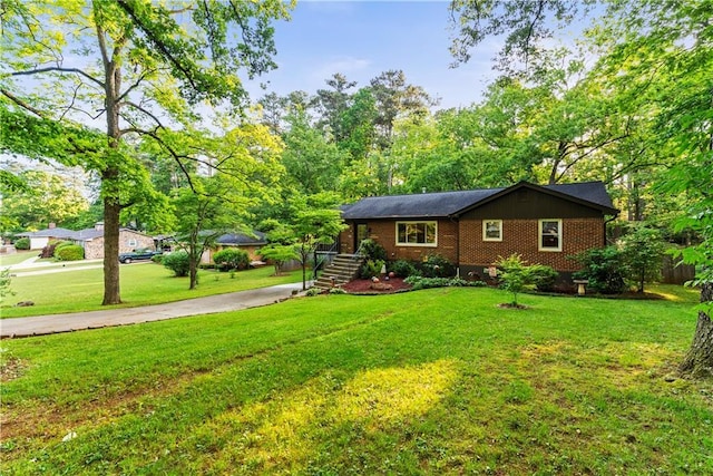 2511 Oak Ave, Tucker, GA 30084 - ranch-style house with brick siding, concrete driveway, and a front lawn