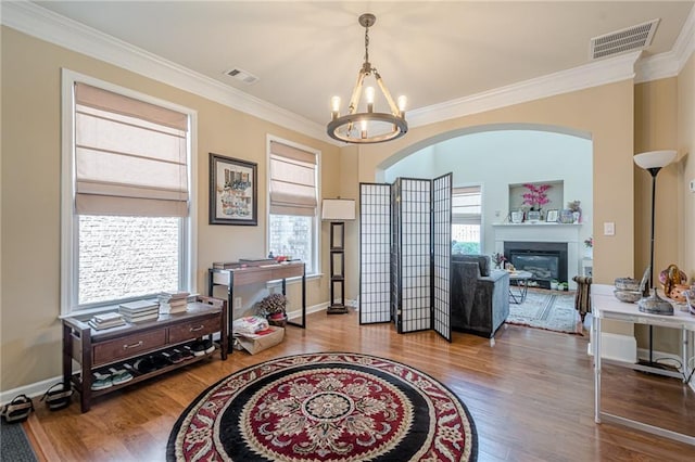 13943 Sunfish Bnd, Alpharetta, GA 30004 - foyer with visible vents, ornamental molding, wood finished floors, and a chandelier